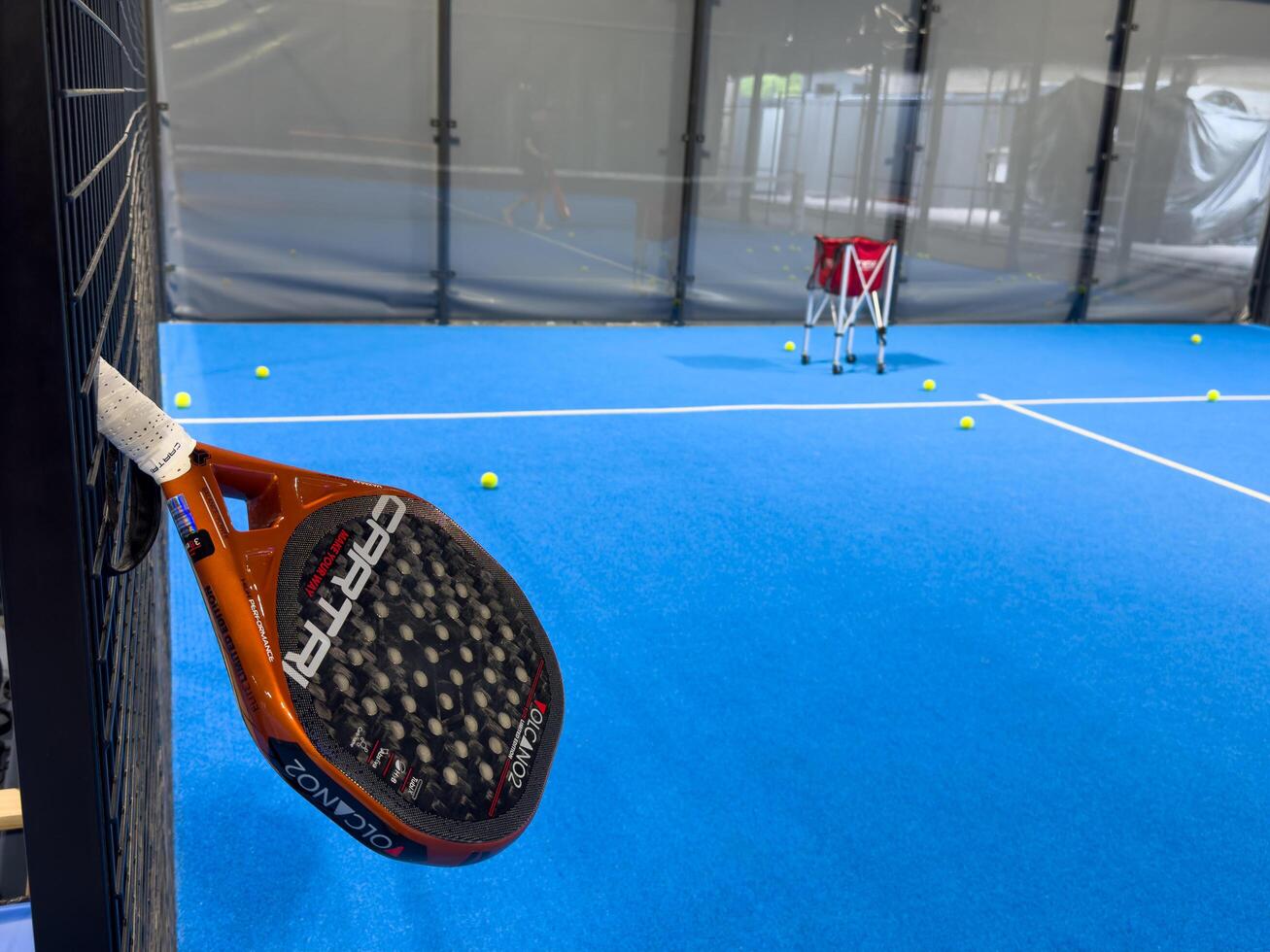 Kyiv, Ukraine, June 22, 2024. Padel Racket Strung in the Outdoor Structure Surrounding the Playing Field in the Background. photo