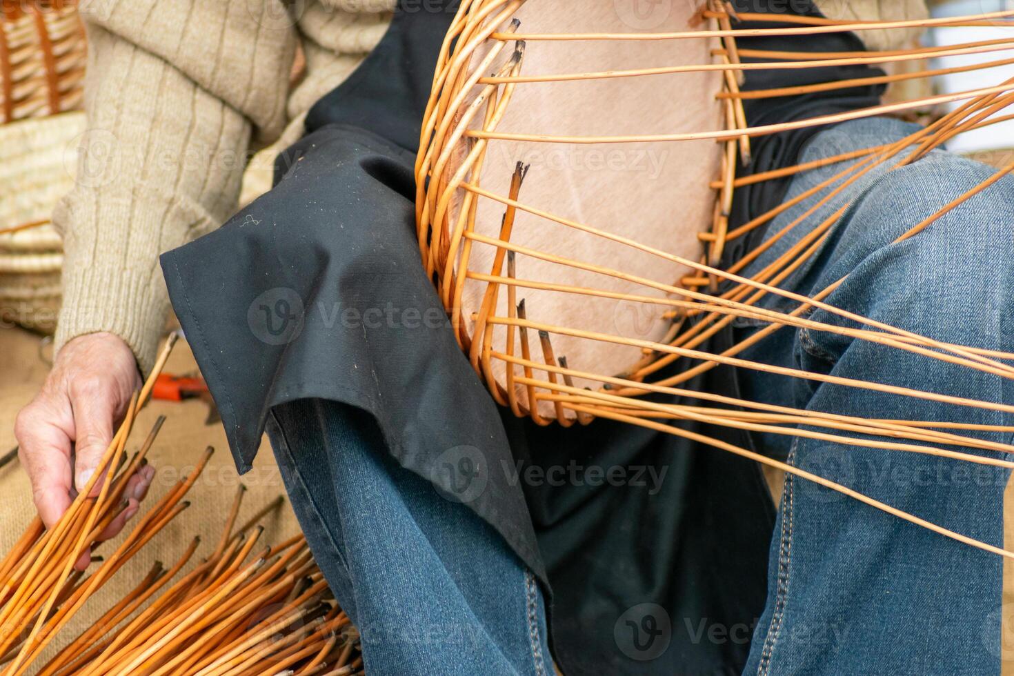 selective focus, artisan's hands making a wicker basket, close-up view photo