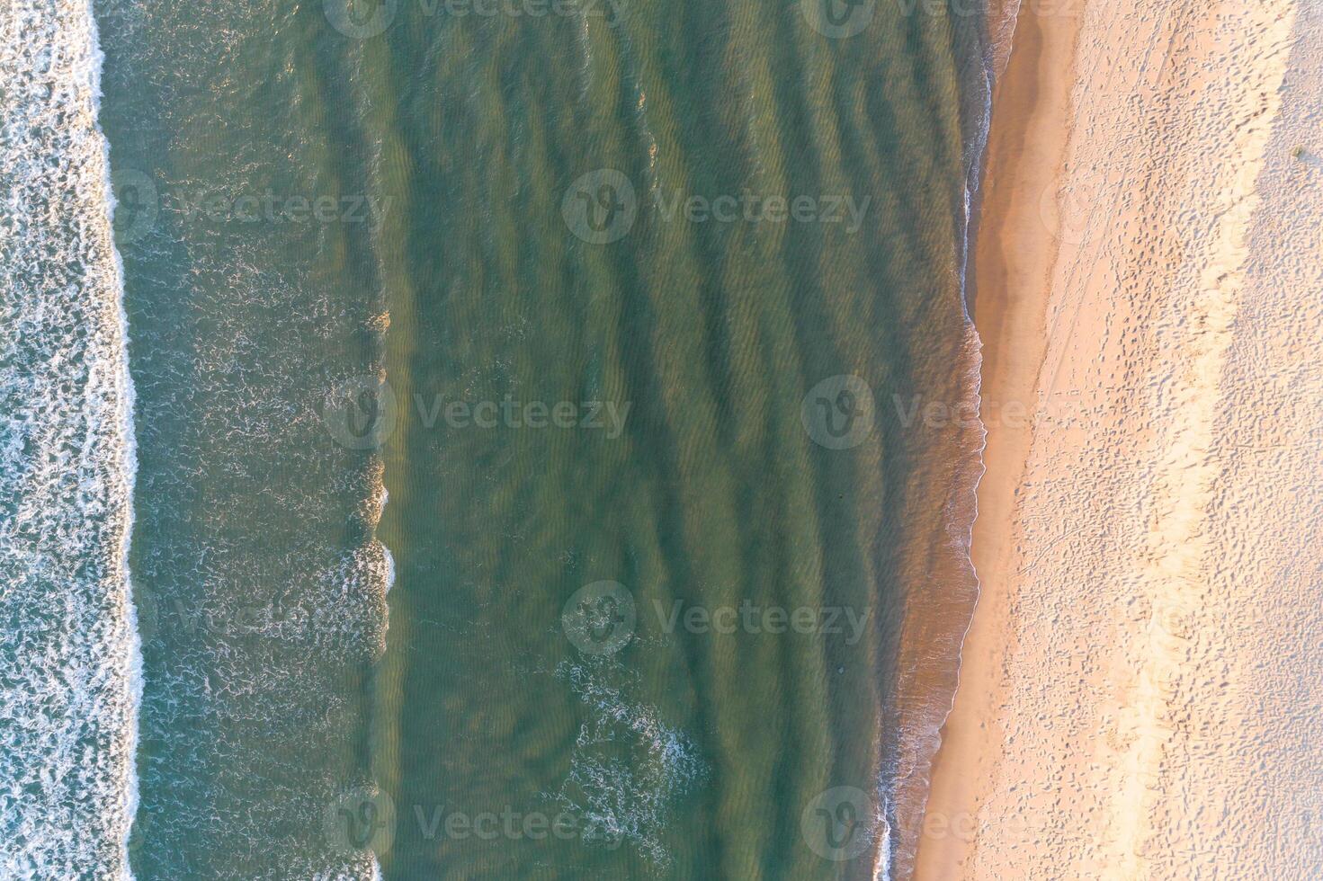 Summer seascape. Aerial drone top view of a beach at dusk photo