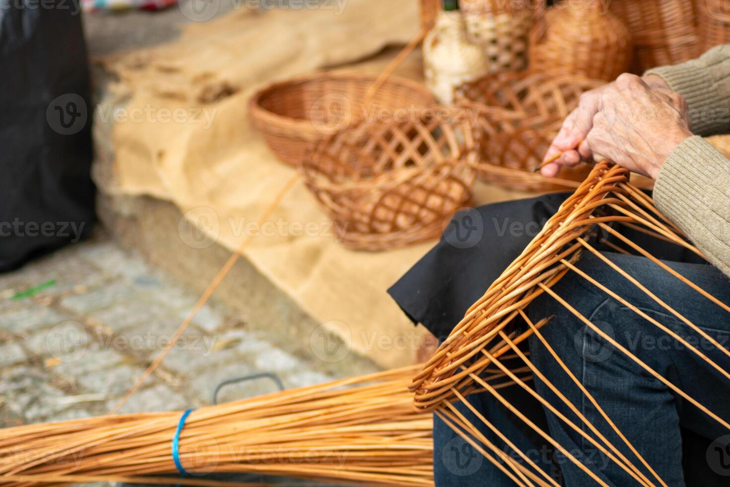 selective focus, artisan's hands making a wicker basket, close-up view photo