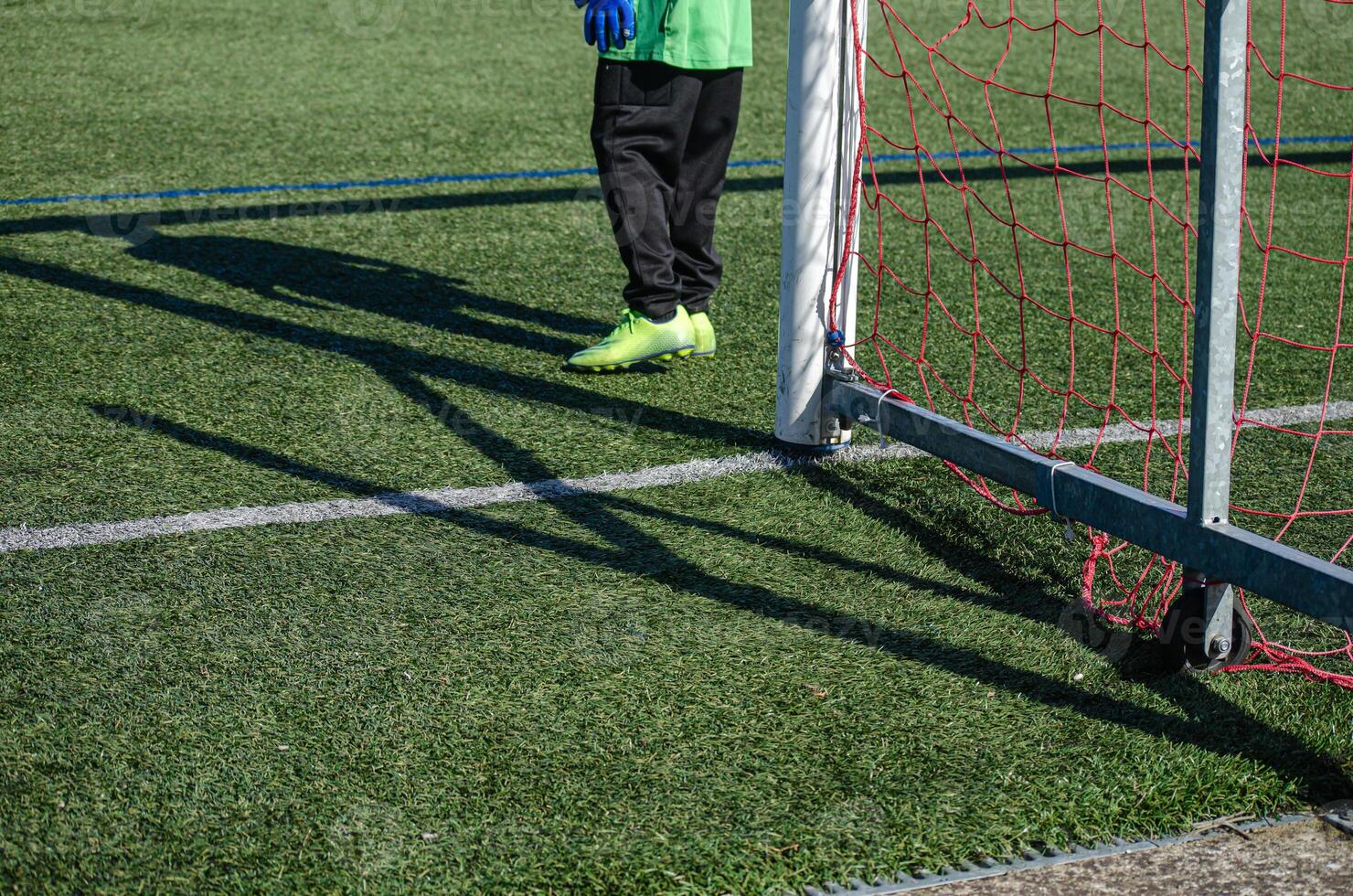 goalkeeper next to the goal of a soccer field during a match photo