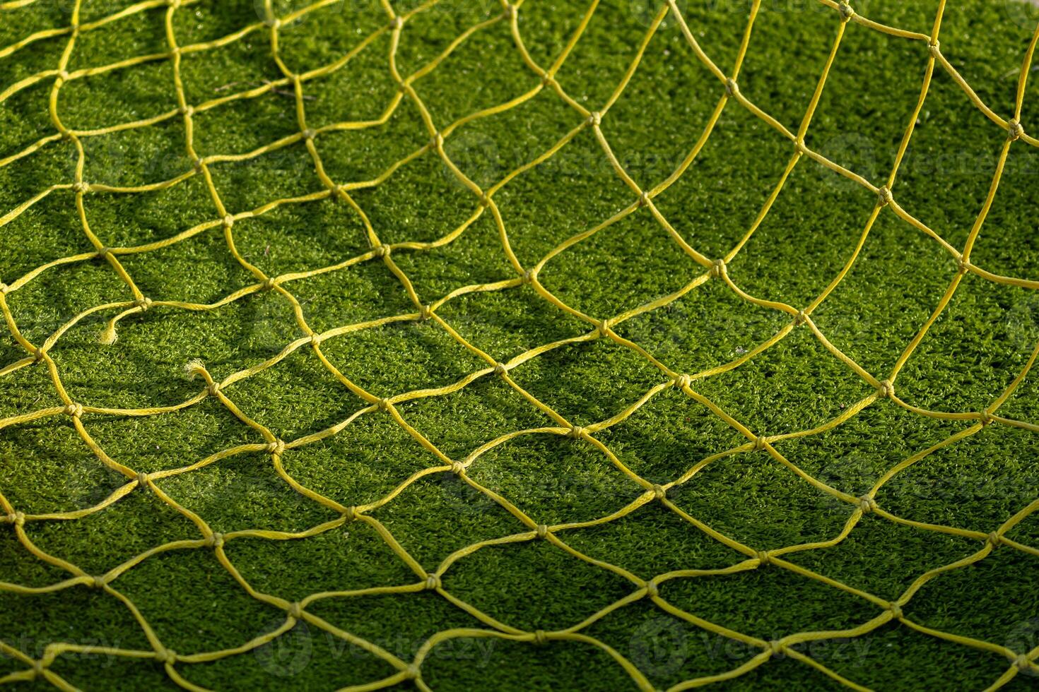 detail of the soccer goal netting on an artificial grass soccer field photo