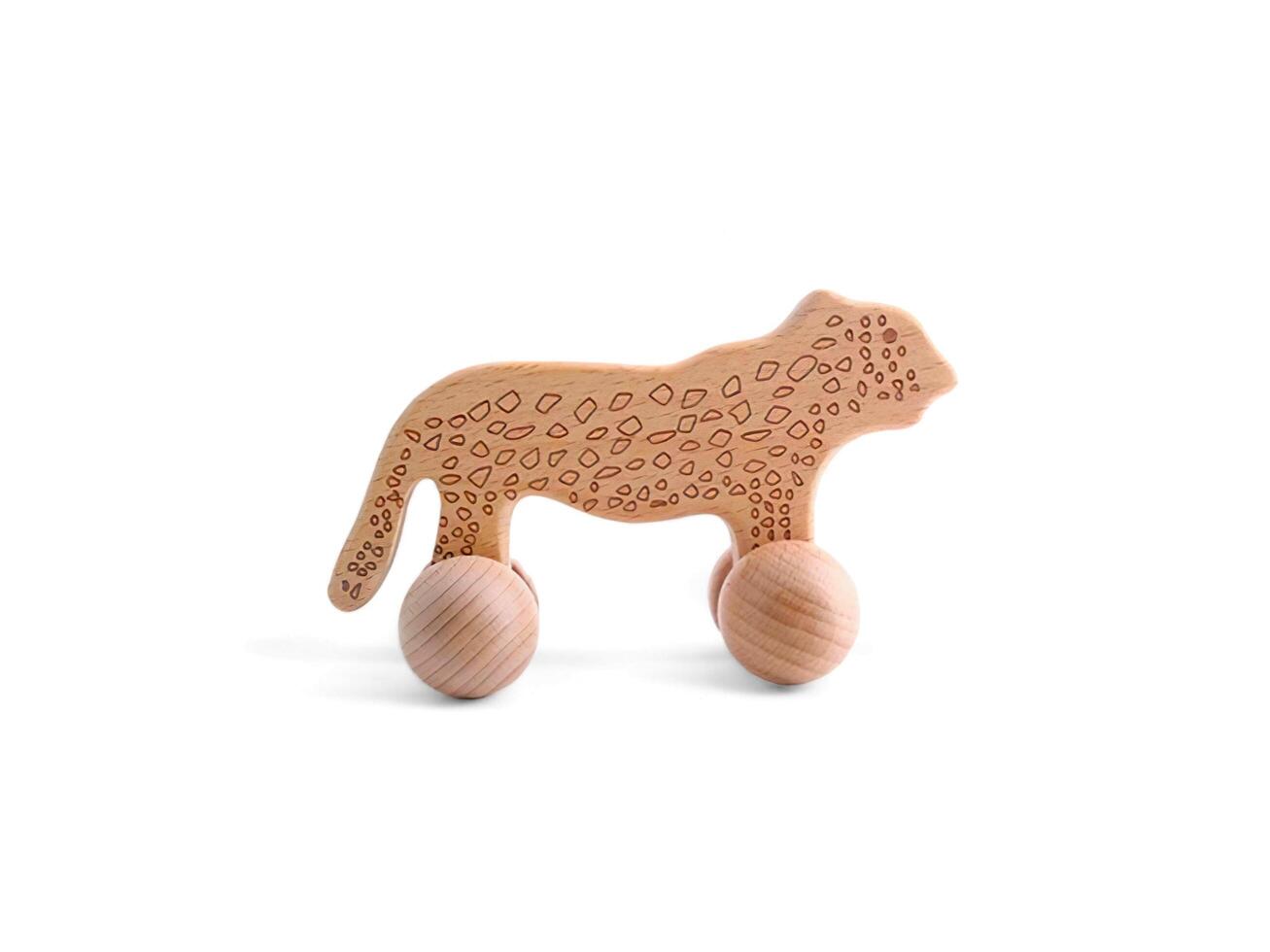 wooden toy car shaped like a leopard character on a white background photo