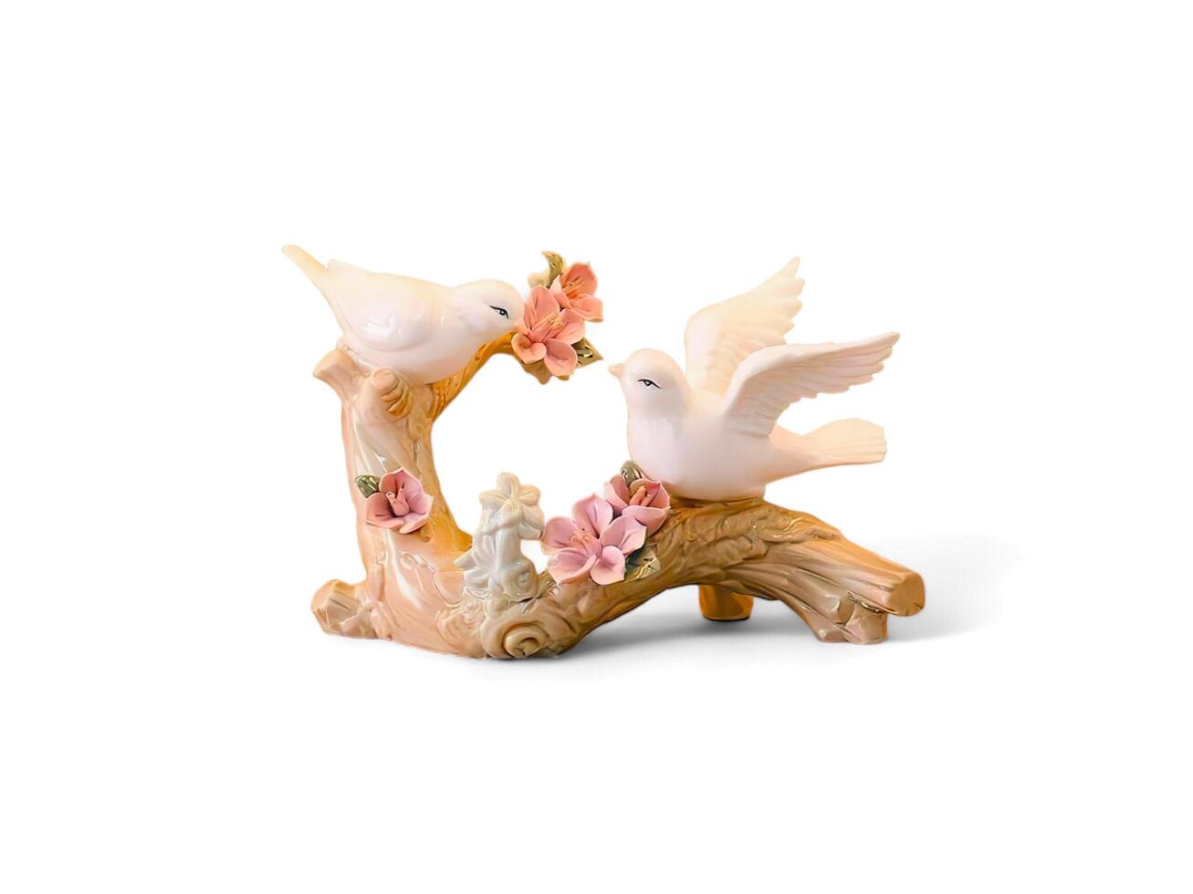 Decorative miniatures of two birds flapping their wings on wood with a white background photo