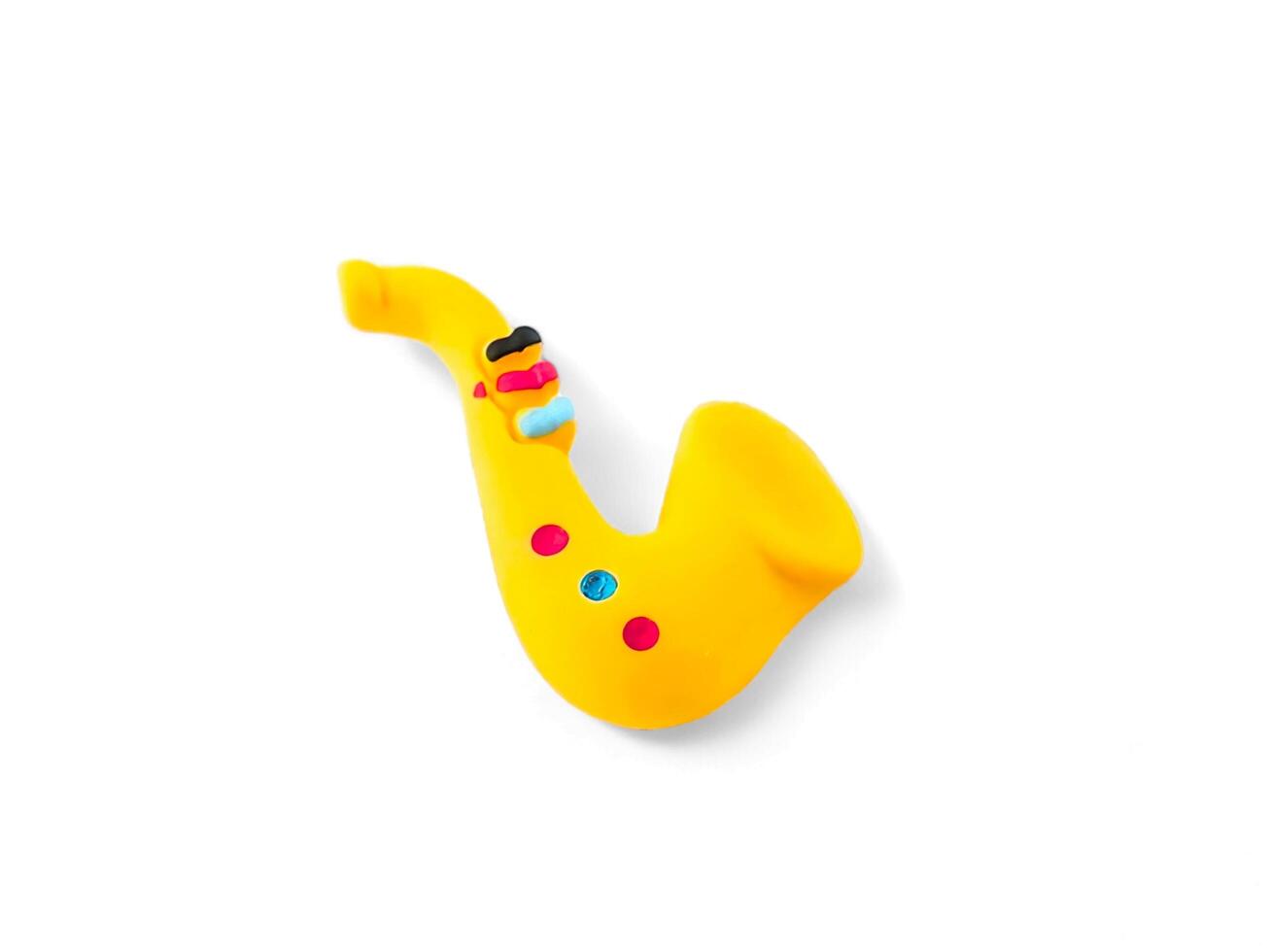 miniature saxophone musical instrument on a white background photo