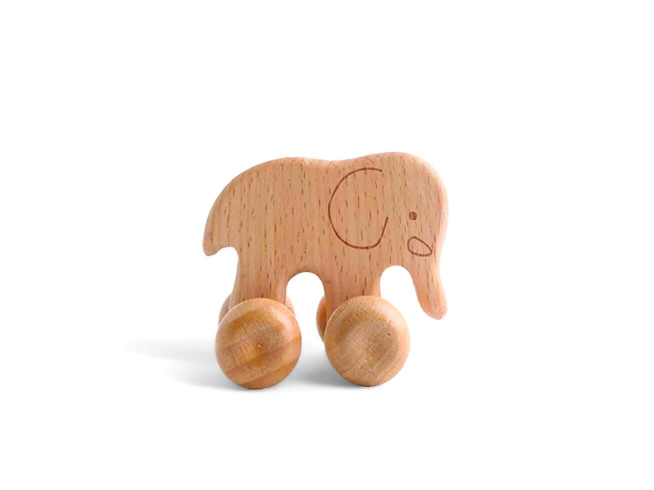 wooden toy car in the shape of a character elephant on a white background photo