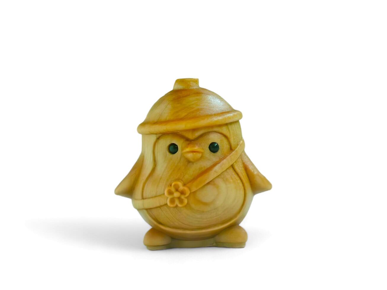 Cute miniature penguin decoration made of wood on a white background photo