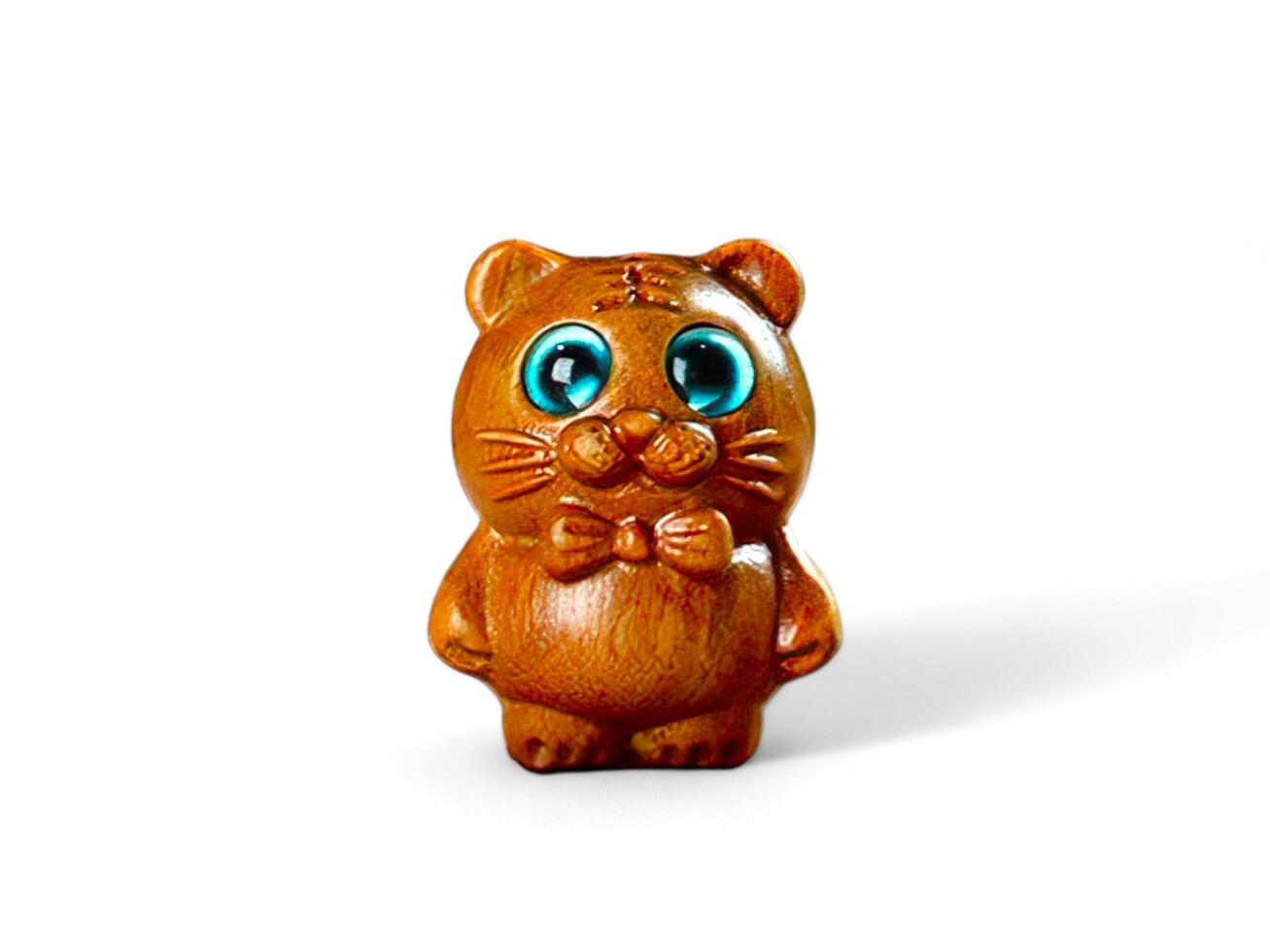miniature wooden cat with a bow tie on a white background photo