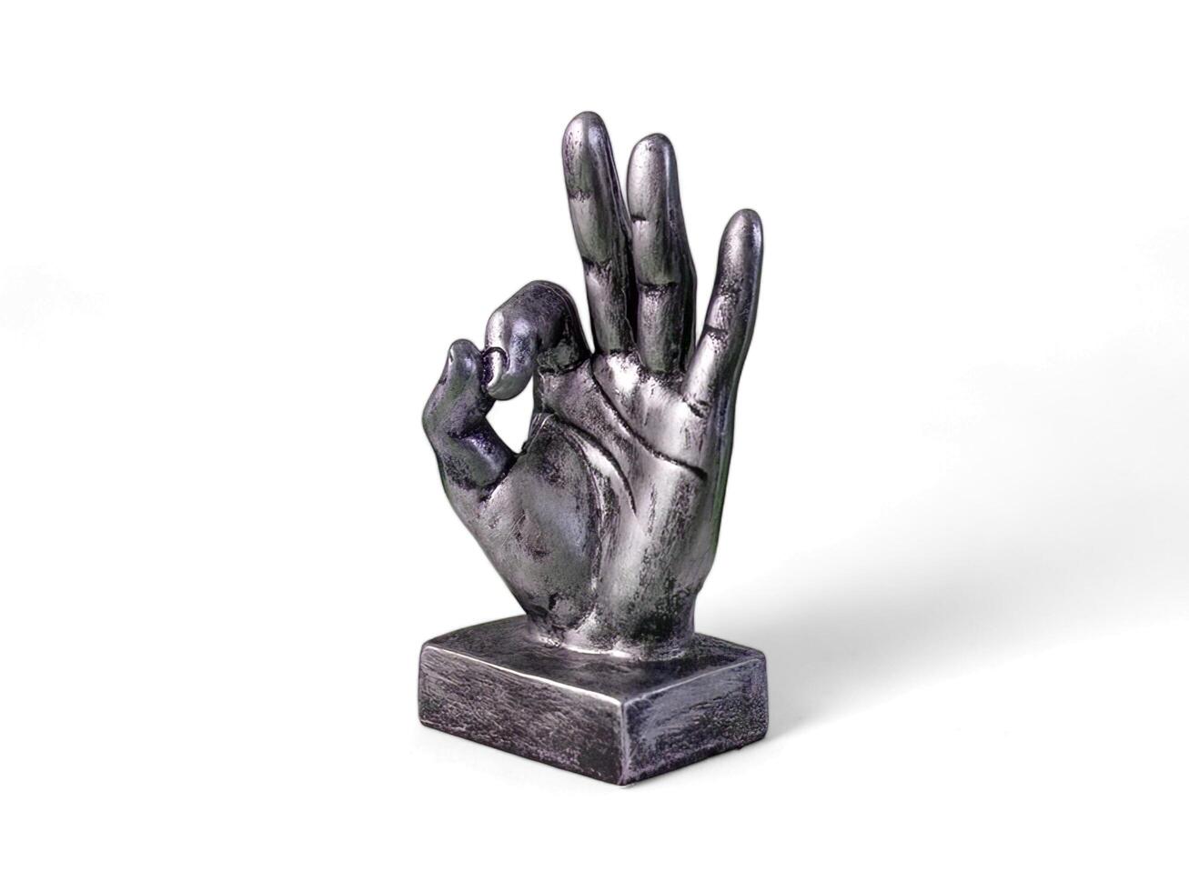 silver hand decoration in an ok shape on a white background photo