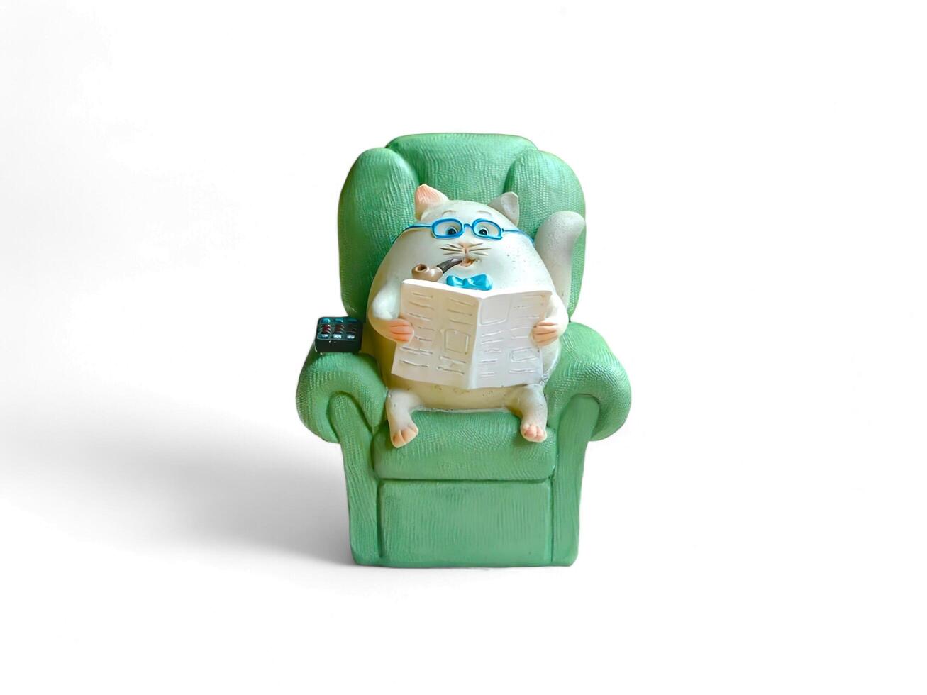 Miniature of cat sit on the couch and reading isolated on white photo