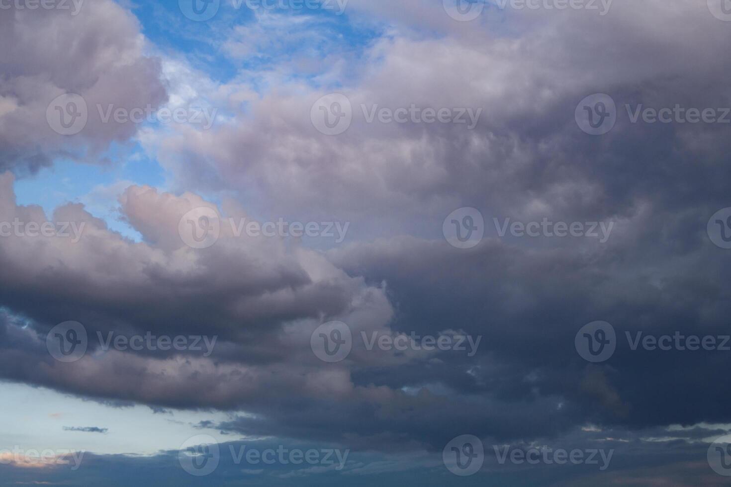Dark storm clouds in the blue sky photo