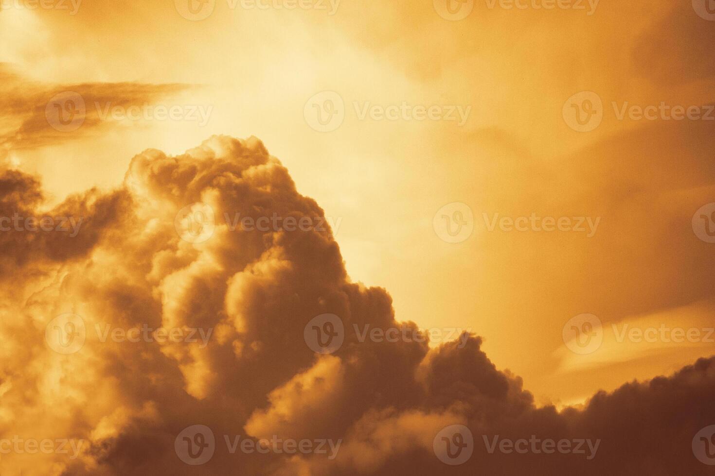 Dramatic view on a orange fluffy clouds as background photo