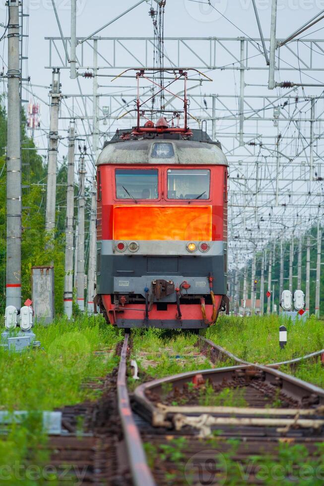 Front view on a passenger electric locomotive on the railroad photo