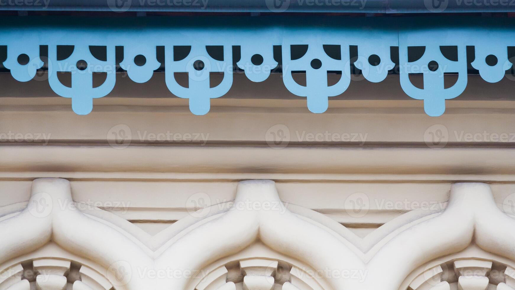 Fragment of the metal decorative cornice with pattern on old stone building photo