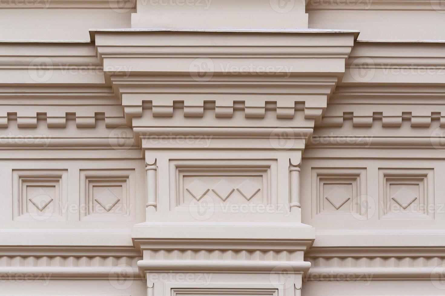 Fragment of the relief frieze with geometric pattern on the wall of beige stone ancient building photo