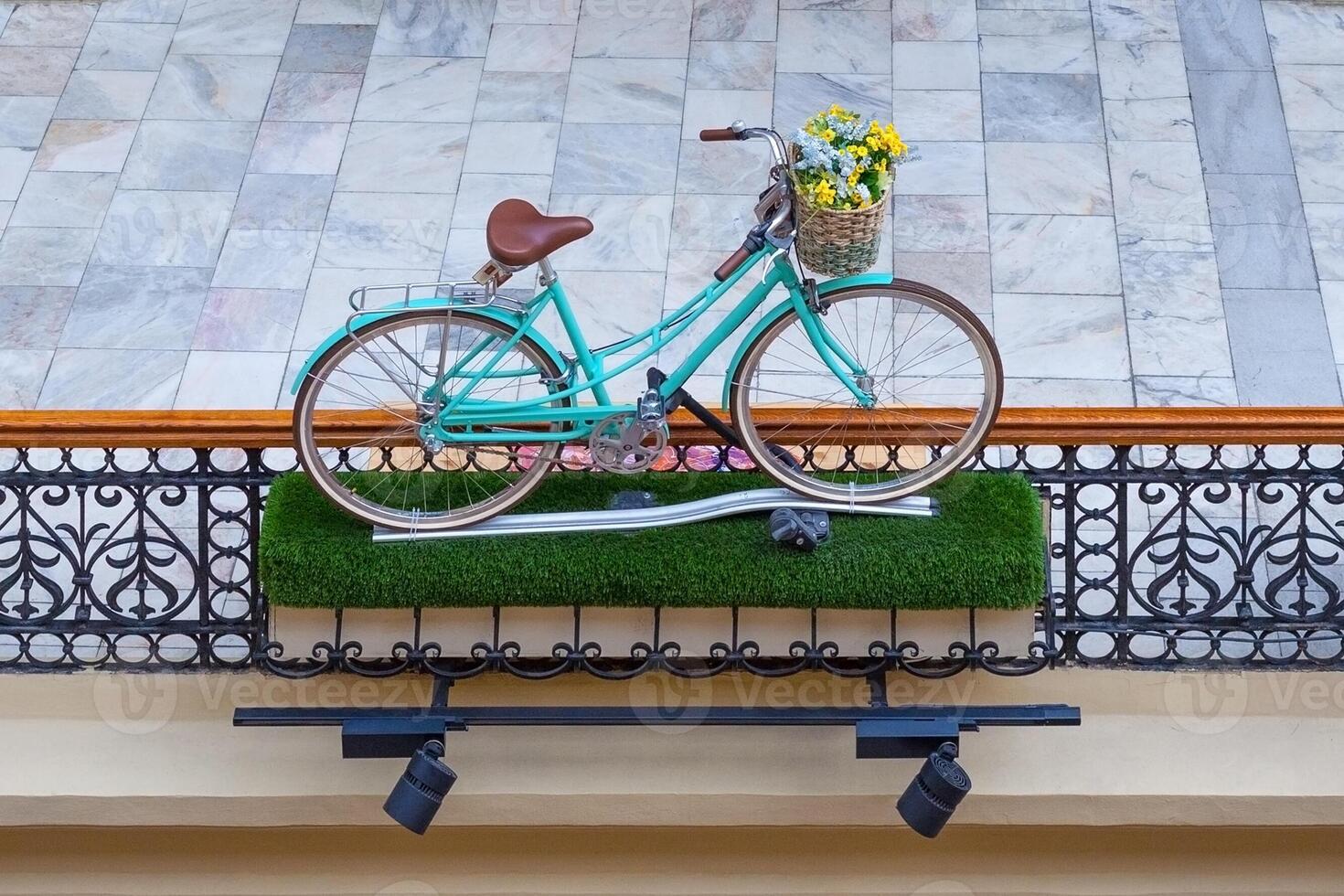 Installation from a turquoise bike in vintage style with flowers in basket photo