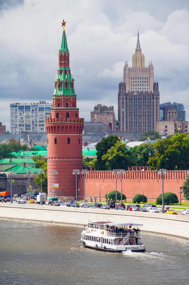 Moscow, Russia, August, 2018 View of the Kremlin Embankment with a pleasure ship sailing along the river photo