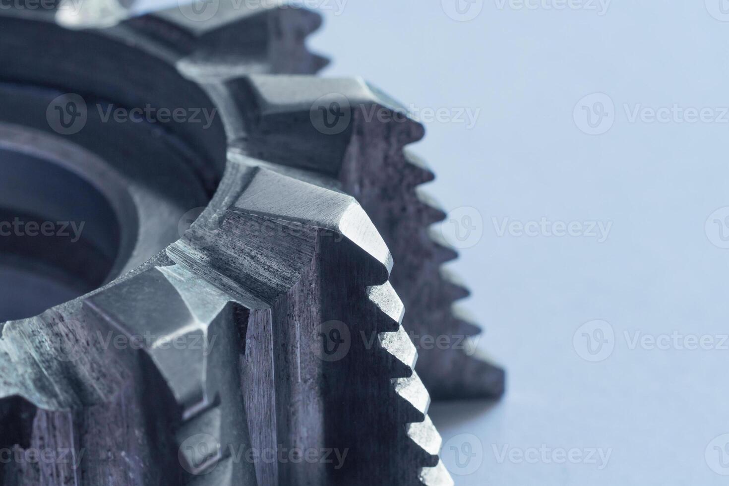 Close up view of a fragment of steel milling cutter on white background with copy space photo