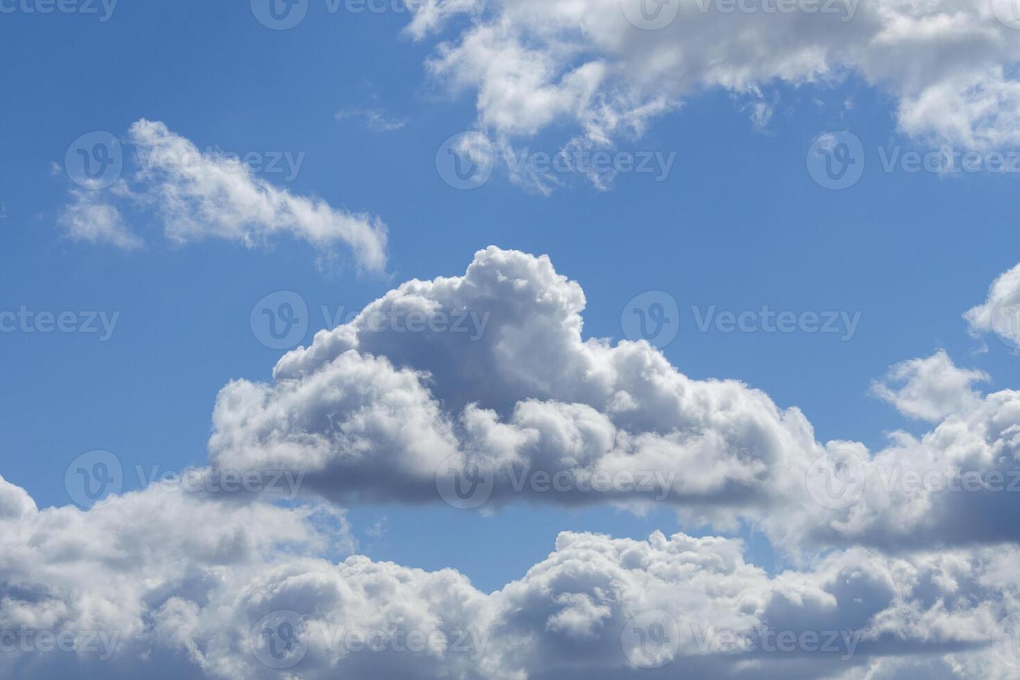 Gray fluffy clouds in the overcast sky photo