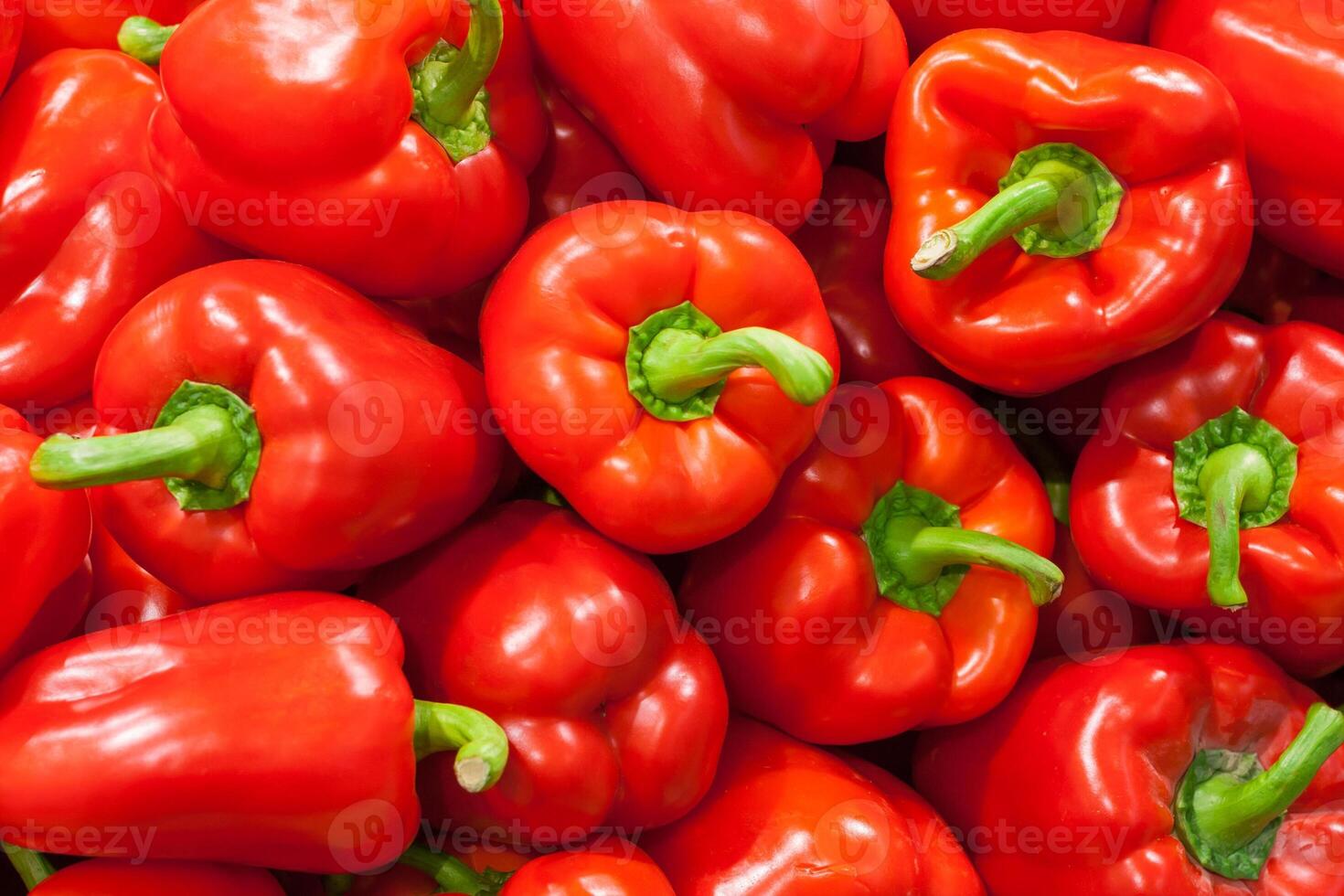 A pile of red bell peppers as background, texture photo