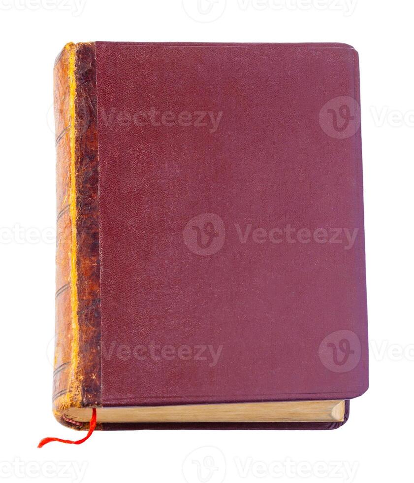 Vintage closed brown book with red bookmark isolated on a white background photo