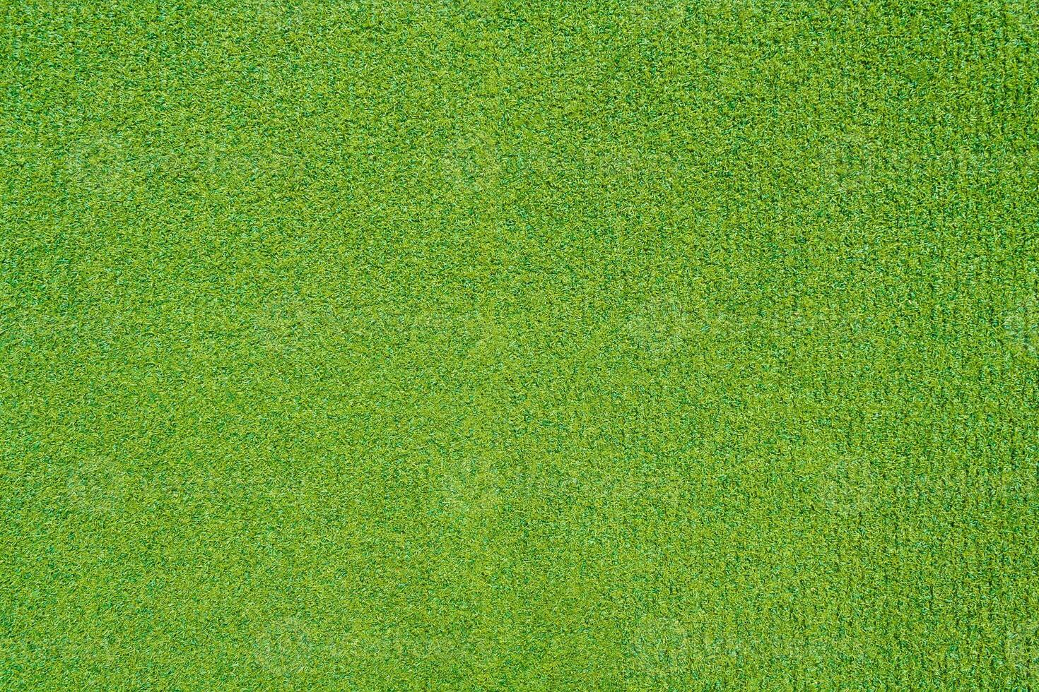 Artificial green grass on the playground as texture, background photo