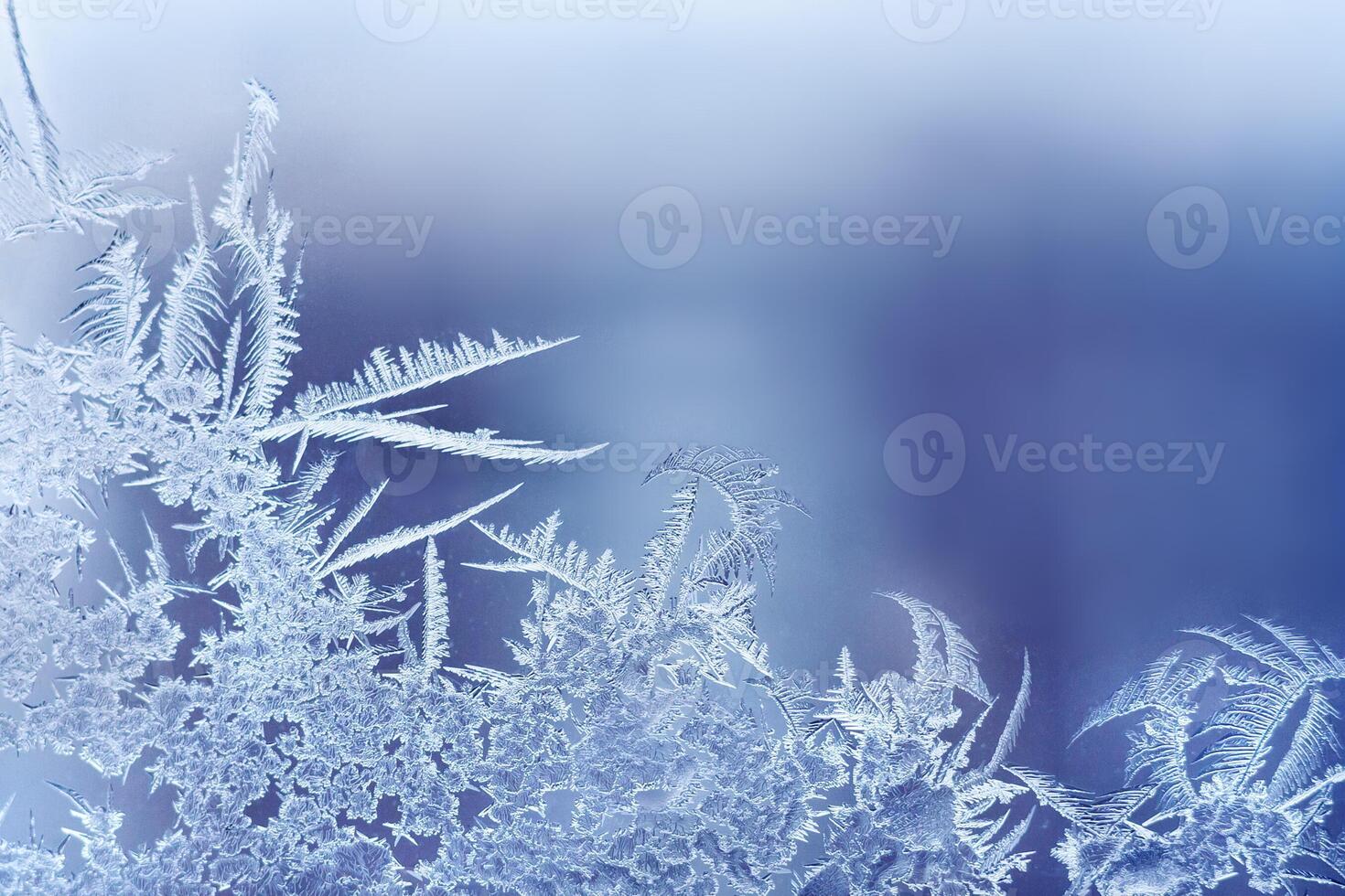 Frosty pattern on the glass window with copy space. Abstract, background, toned photo