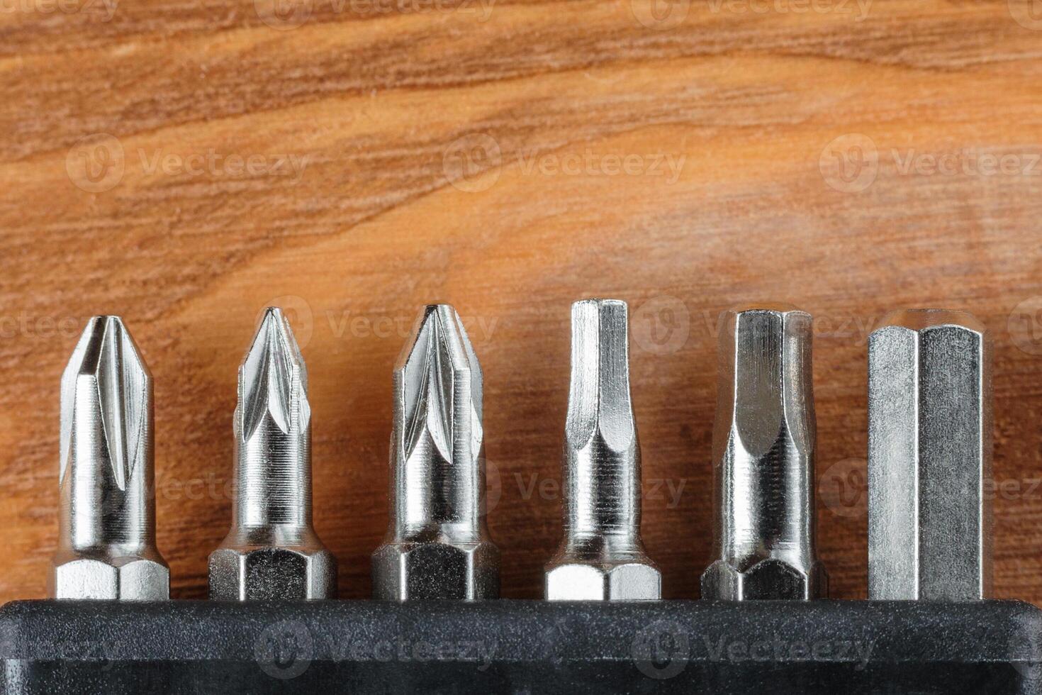 A set of tools collection from heads for screwdriver bits on a wooden table with copy space photo