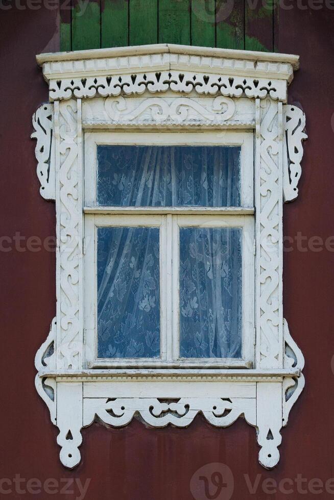 Carved wooden window frame with patterns photo