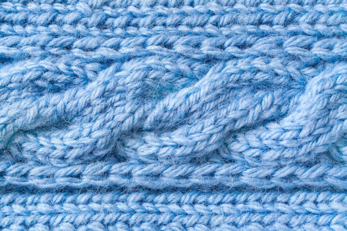 Blue woolen fabric with a fragment of a pigtail pattern photo