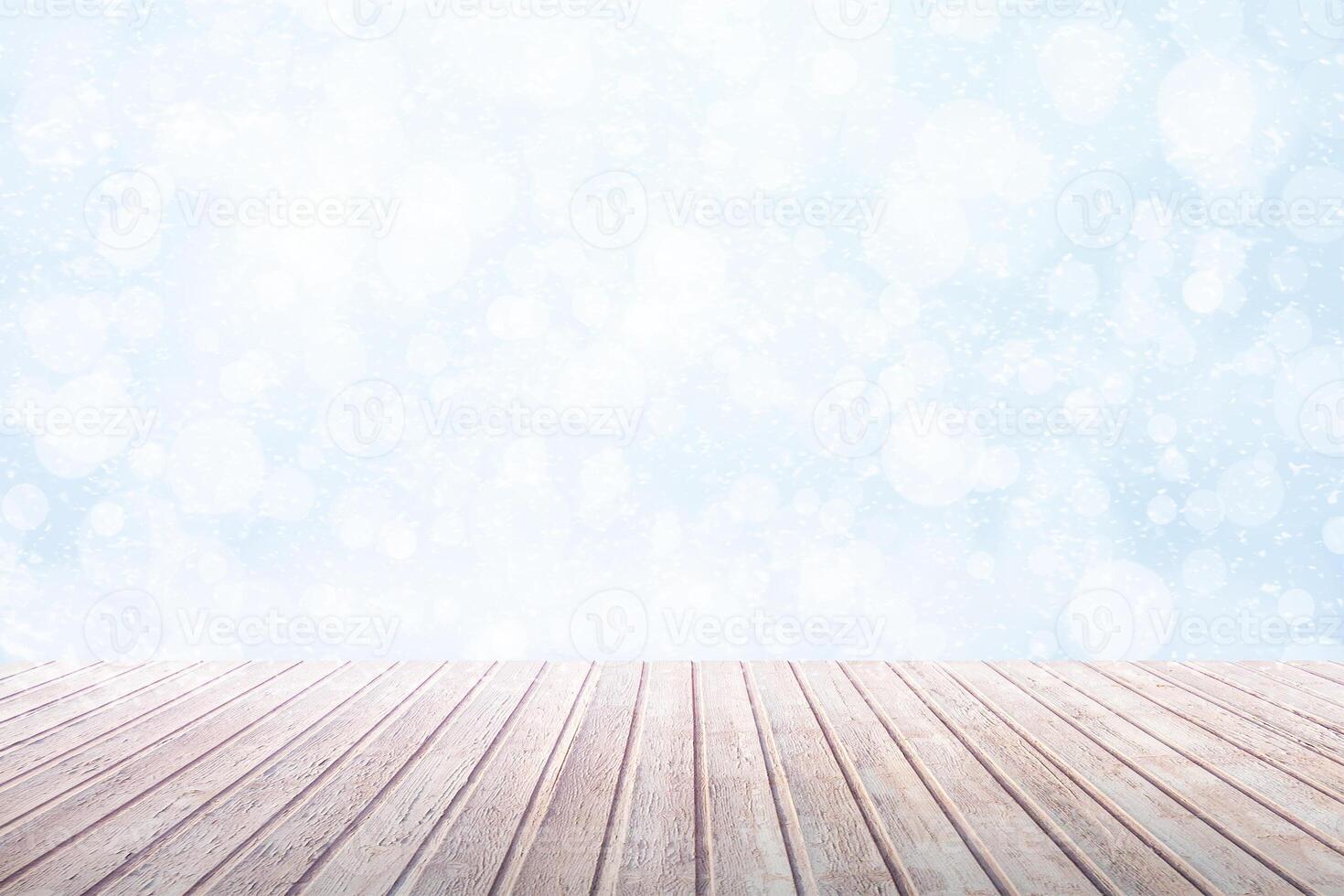 View on a brown wooden table against a winter snowfall with bokeh as background photo