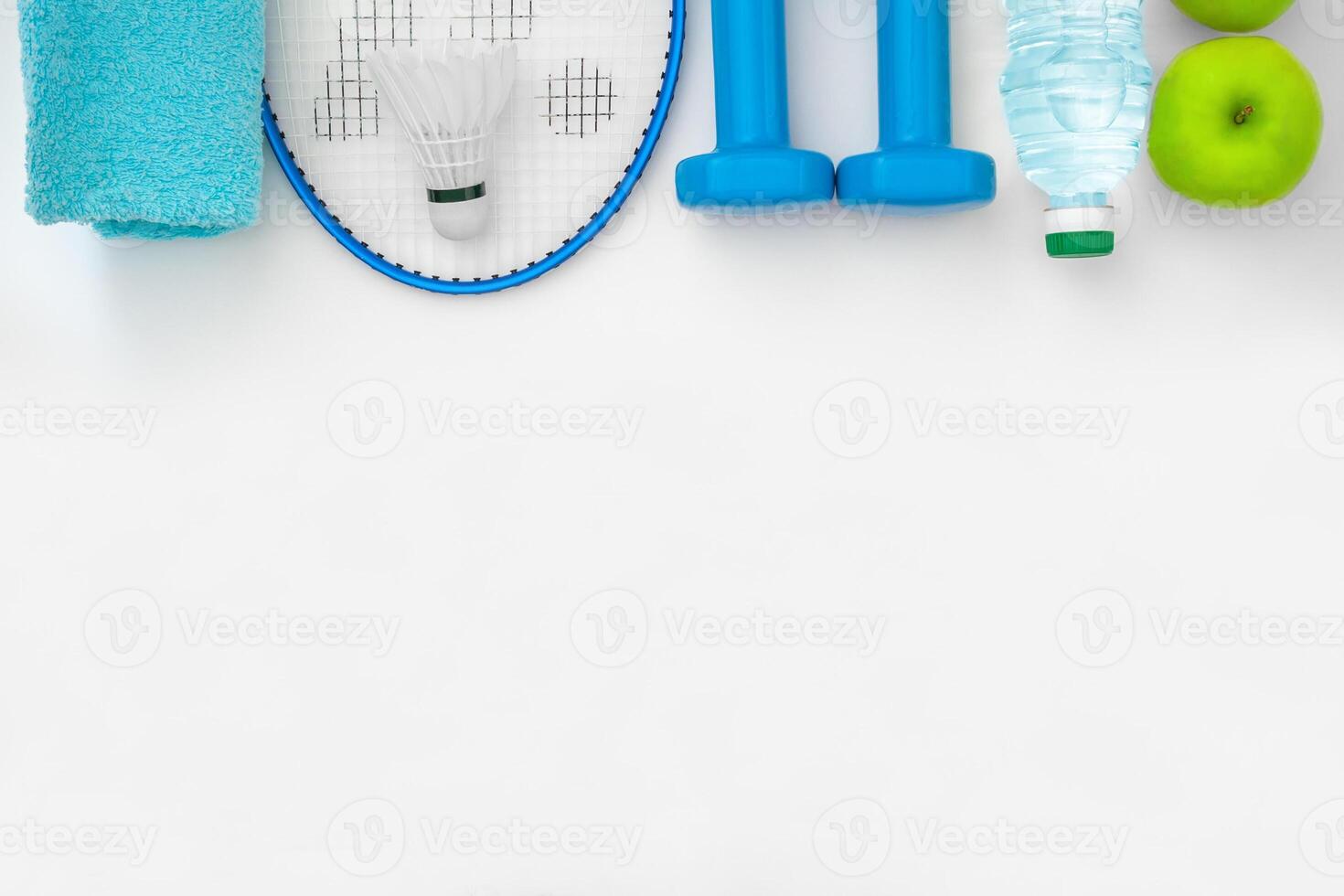 Top view on a attributes of a healthy lifestyle food, sports equipment on a white background with copy space photo