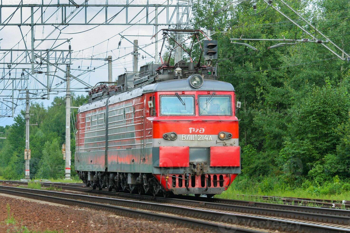 Moscow region, Russia, July 2018 Cargo electric locomotive of the russian railways VL11 on the railroad on a background of green trees photo