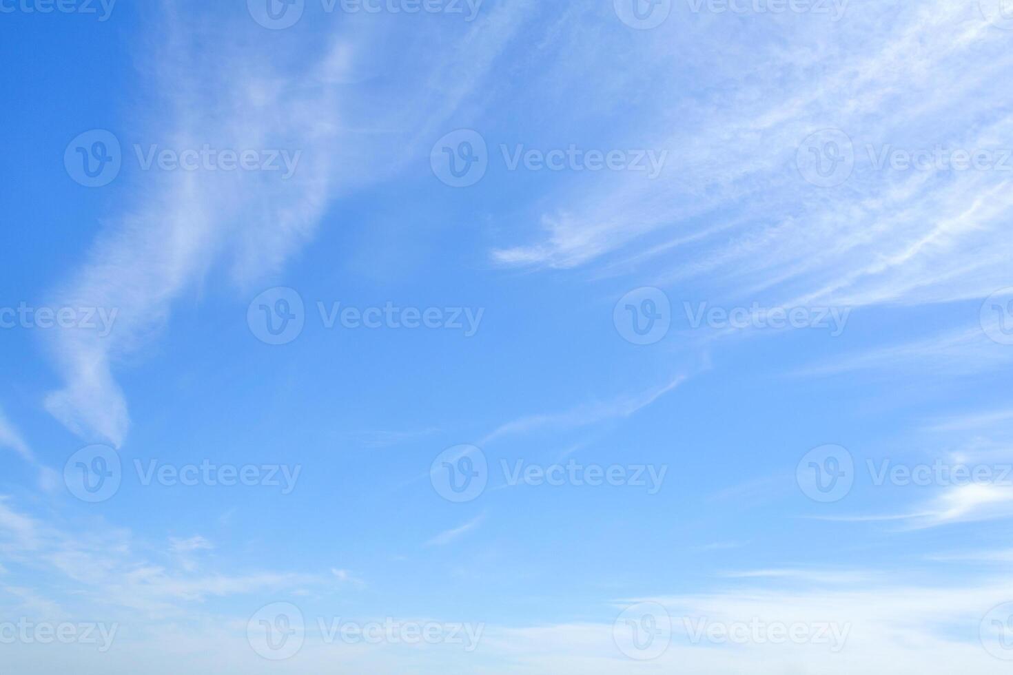 White feather clouds in bright azure sky as background with copy space photo