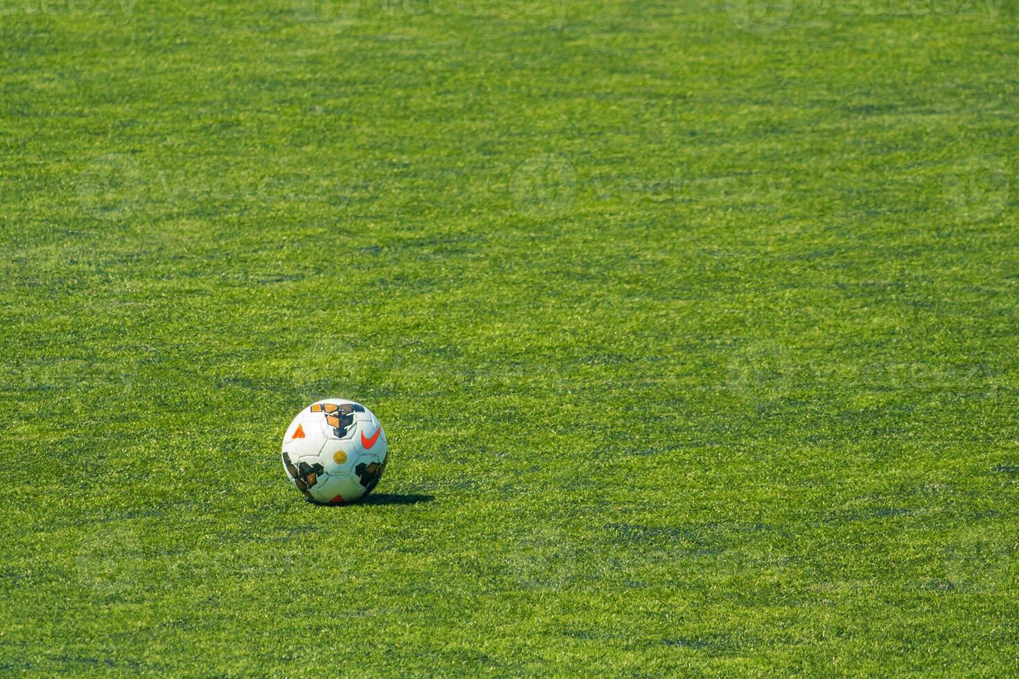 View of a professional leather soccer ball on the green field with copy space photo