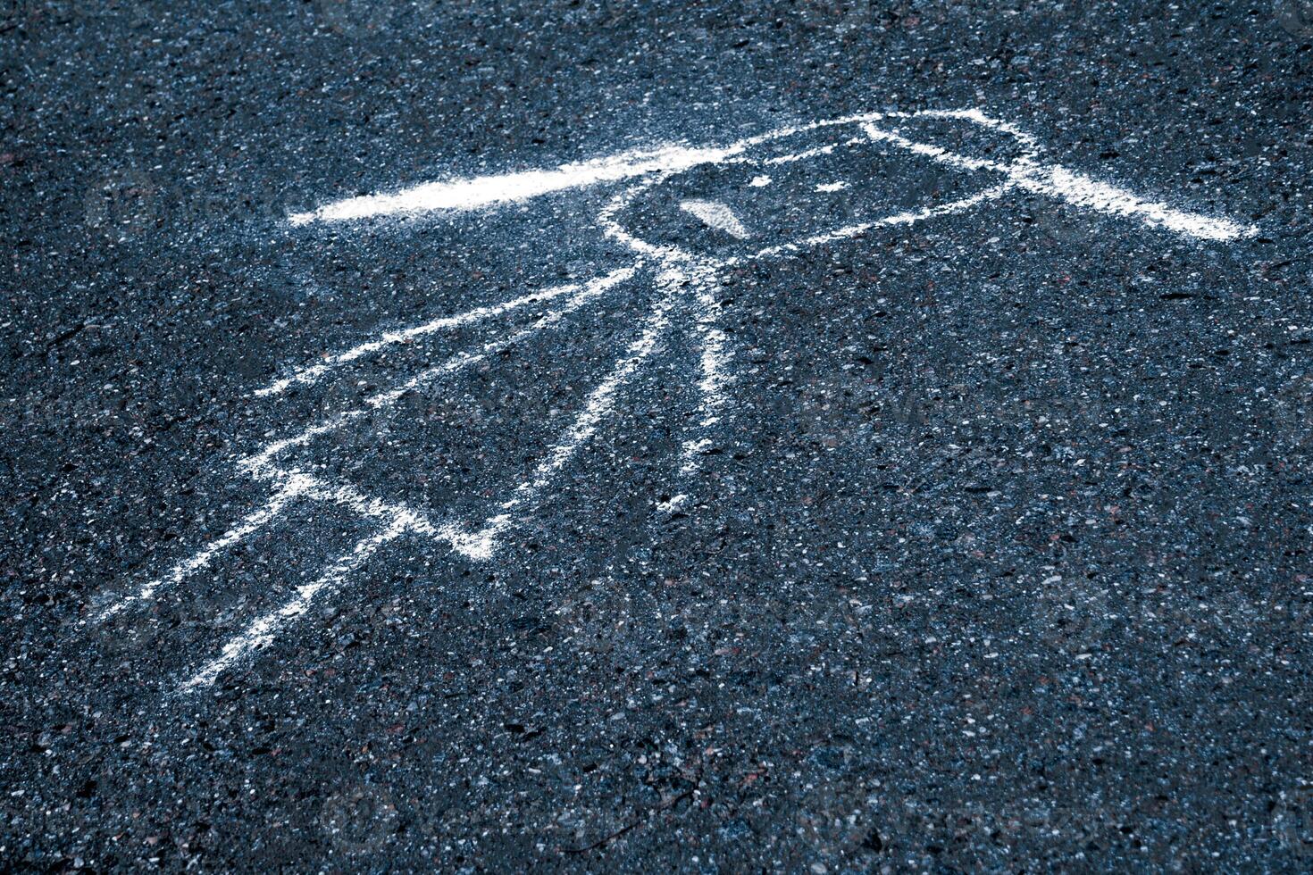 Sad child painted chalk on the asphalt with copy space photo