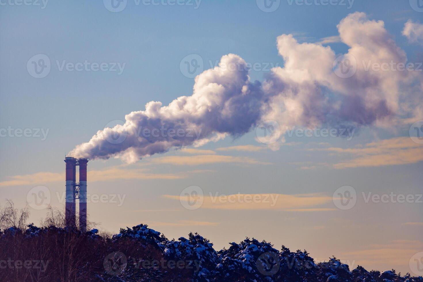 Steaming chimney's on a background of blue sky photo