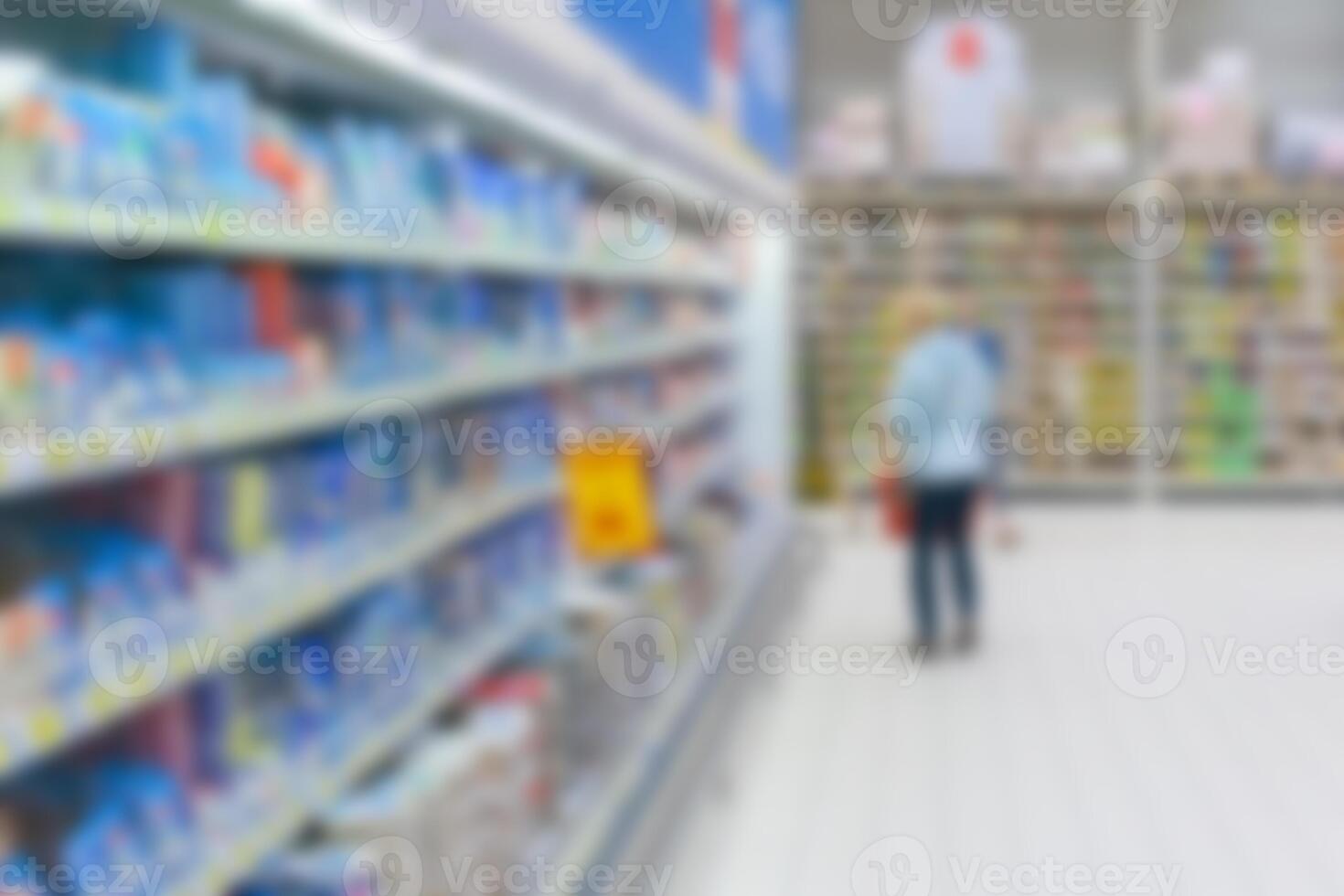 View of a blurred interior of supermarket with consumer photo