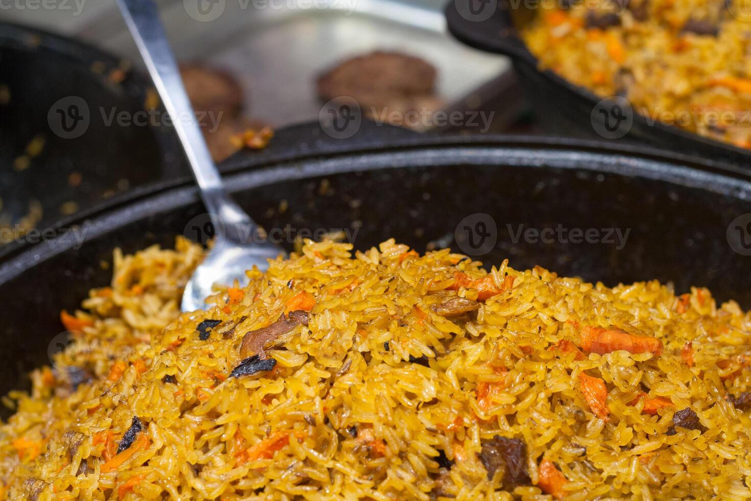 Cooking a pilaf on a frying pan. Shallow depth of field photo