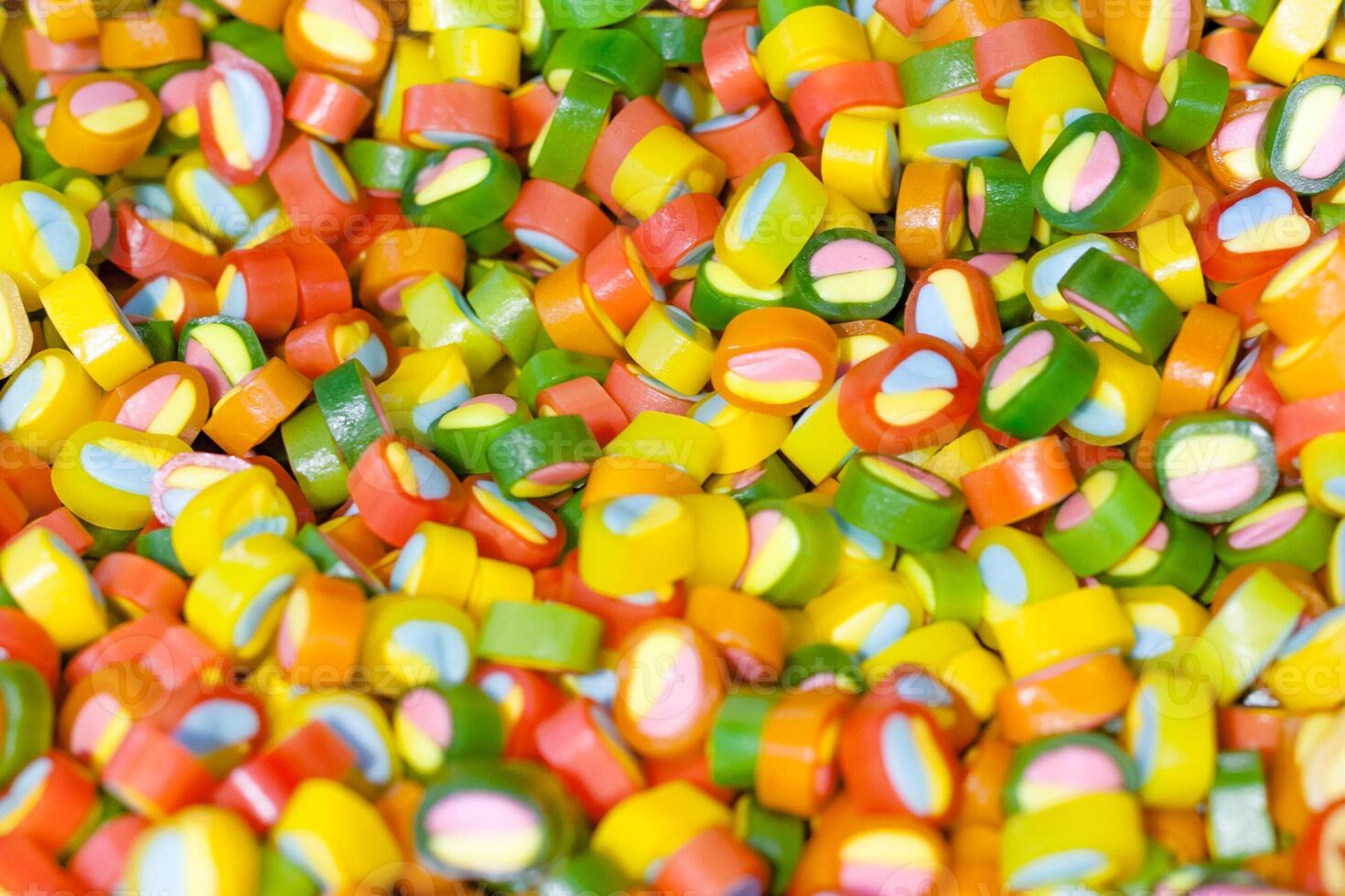Multicolored candies in store as background, texture photo