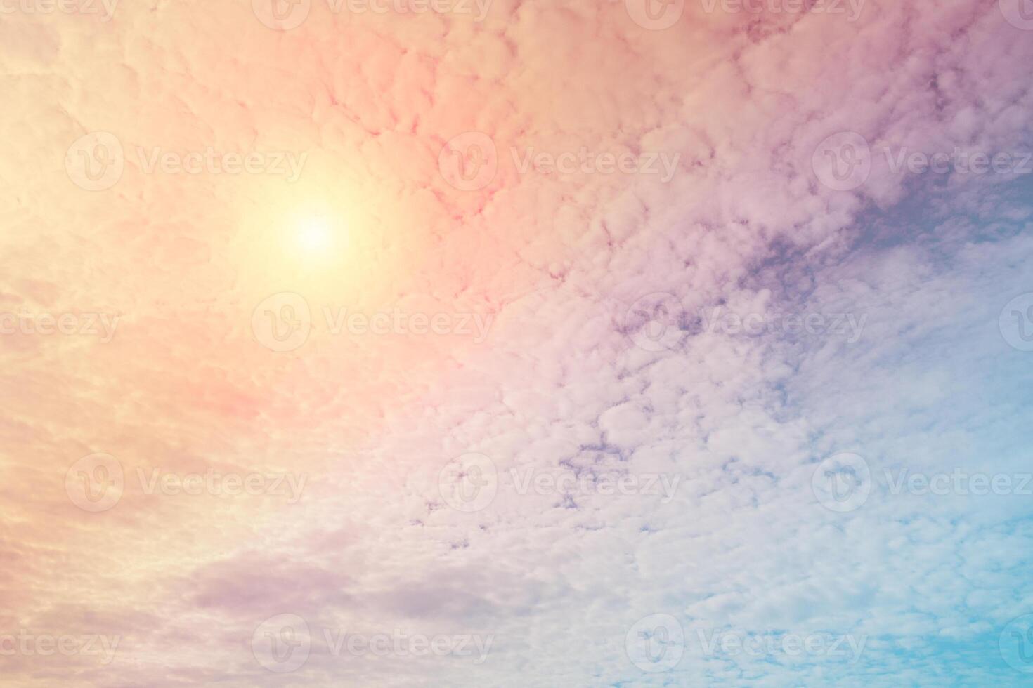 Abstract view on a fantastic soft clouds with pastel color and sun in the sky as background photo