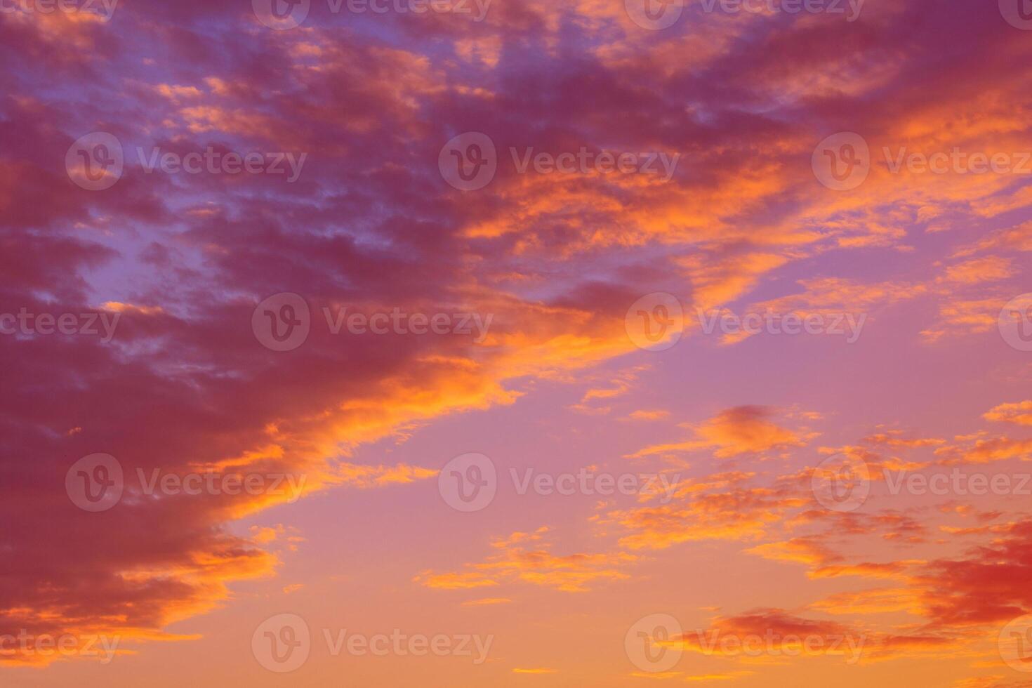 Dramatic view on a orange clouds in the evening sunset sky photo