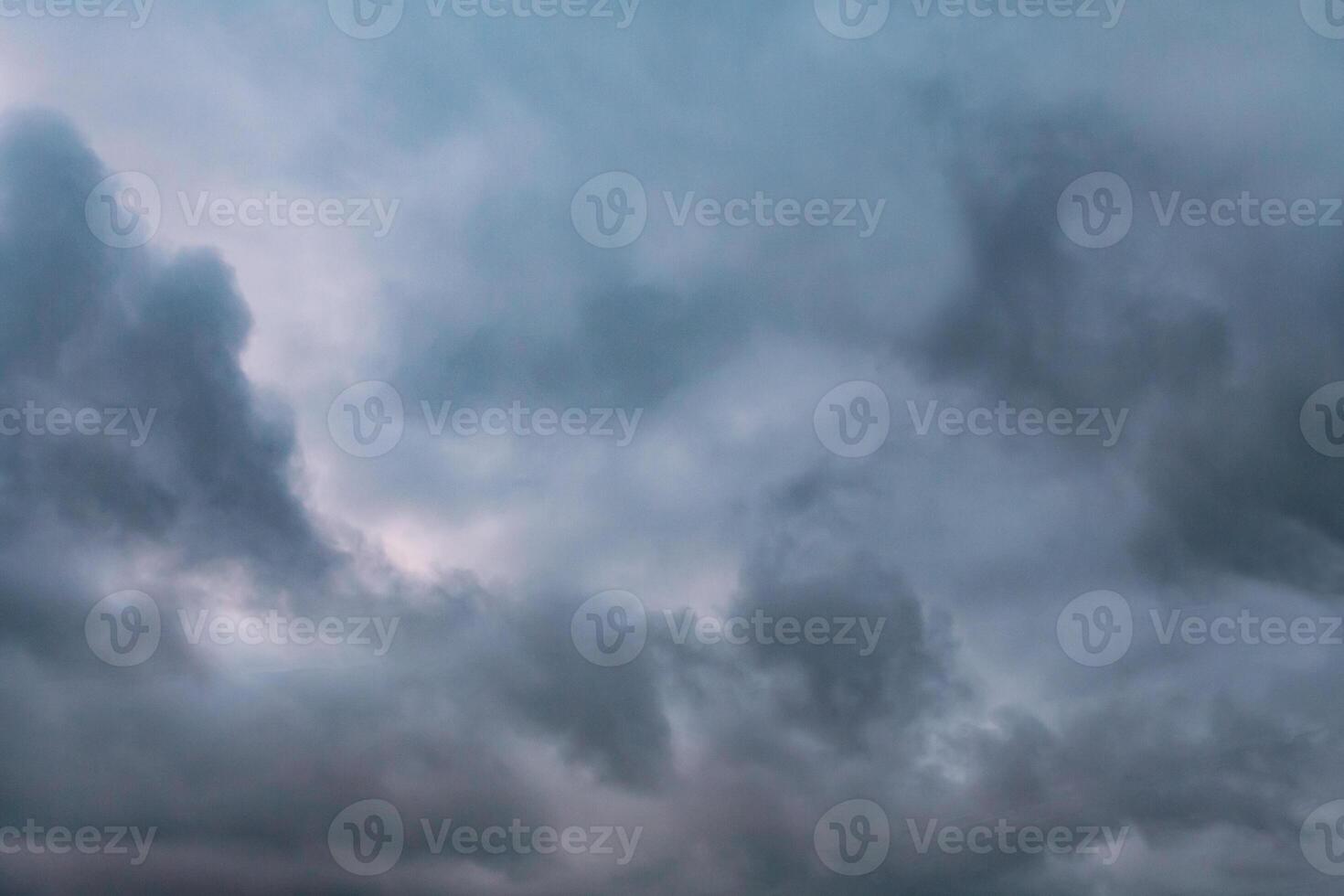 Low leaden storm clouds on a gray sky background photo