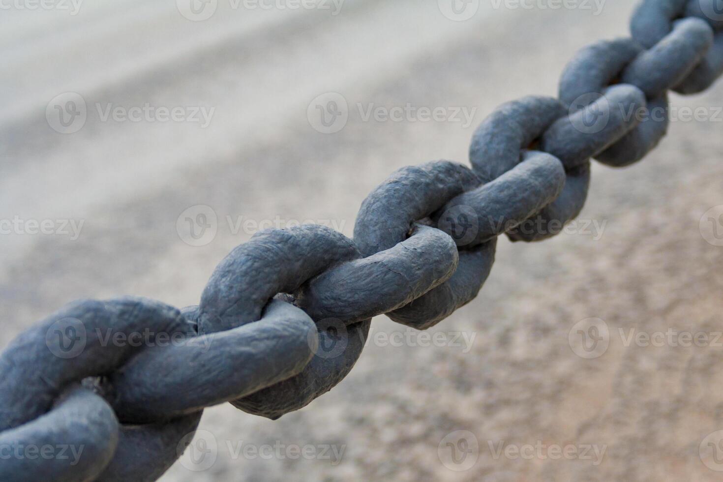 Close up view on a black Iron chain on a neutral blur background photo