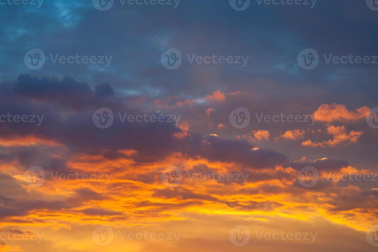 Dramatic view on a orange clouds in evening sky photo