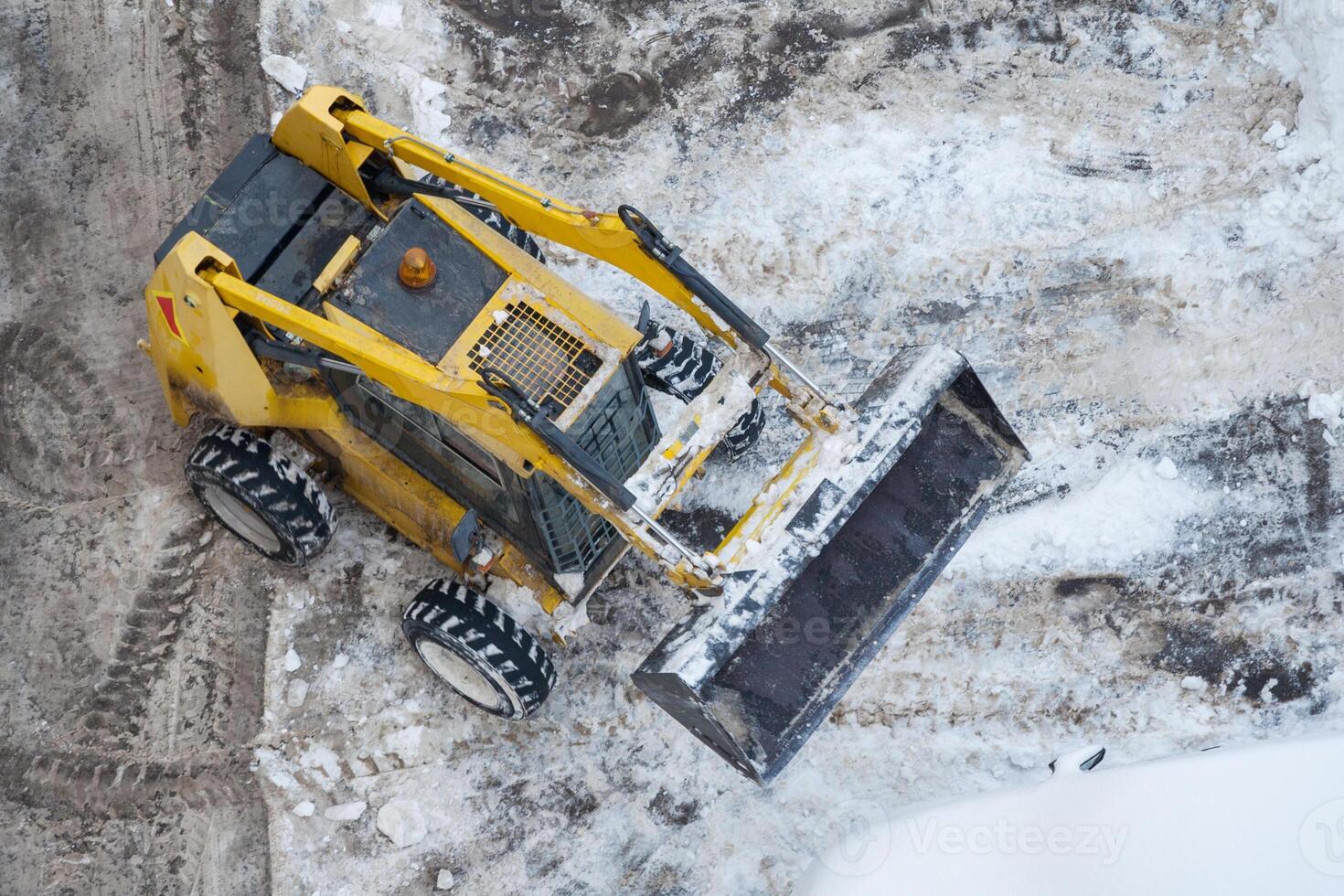 Top view on a snow-removing machine on a dirty street photo