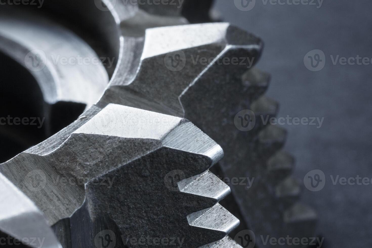 Close up view of a fragment of steel milling cutter on a dark background photo