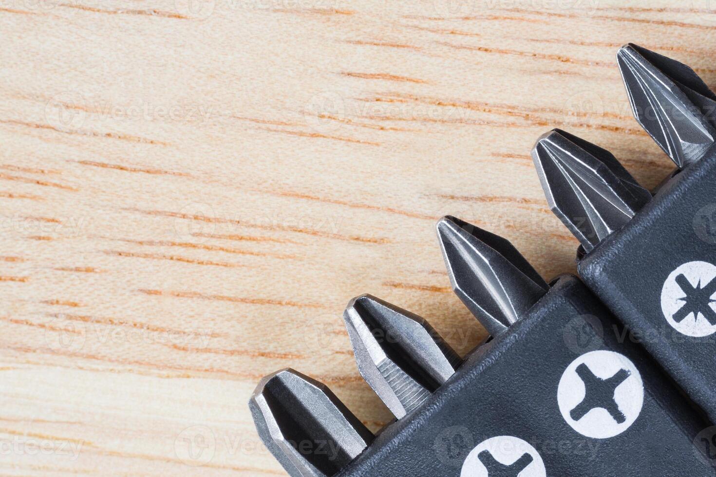 A set of tools collection from heads for screwdriver or bits on a wooden table photo
