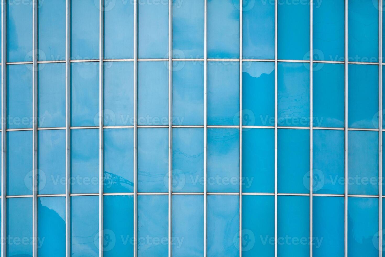 Abstract view of a fragment of facade of a modern glass building as texture, background photo