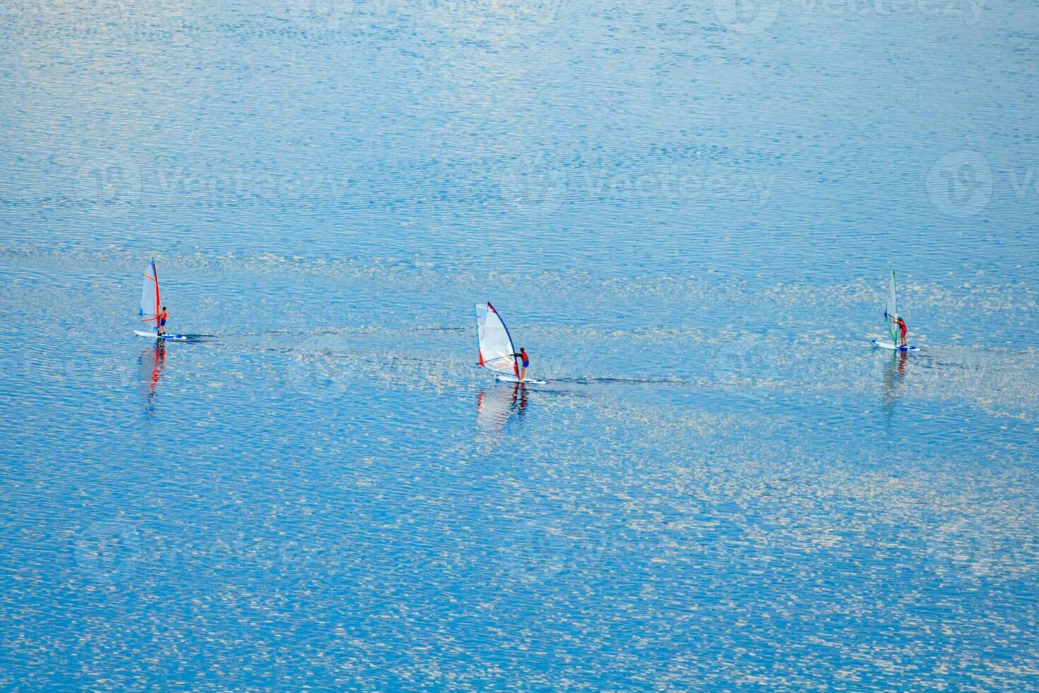 Aerial view on a windsurfers on the turquoise water photo